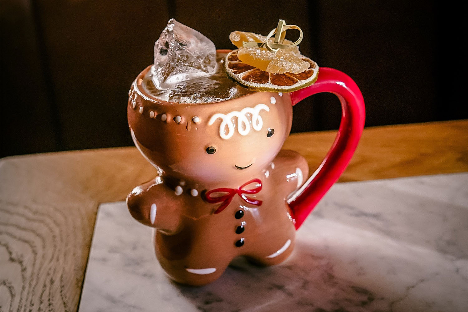 Cocktail in a mug shaped like a gingerbread man cookie