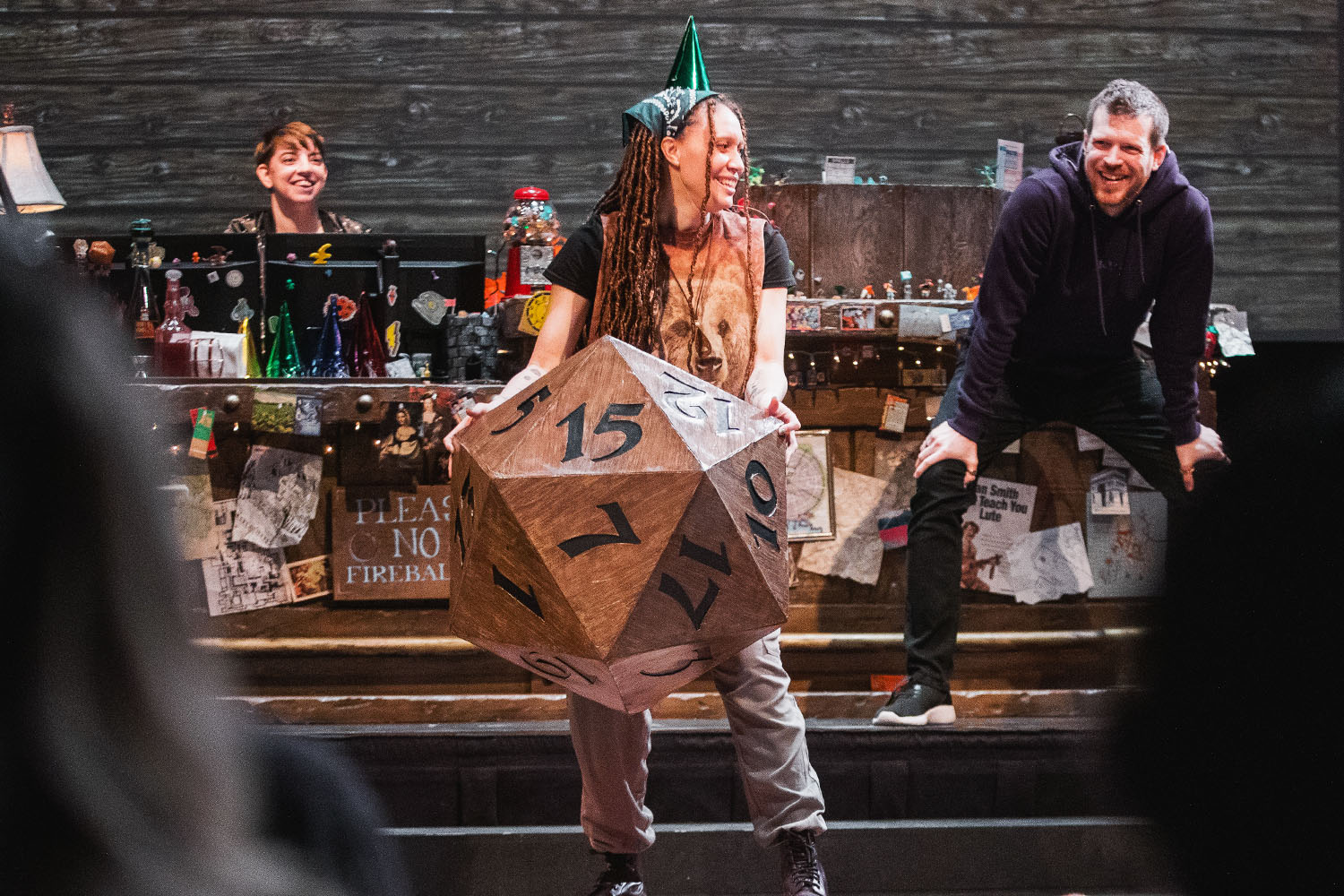 Woman with 20-sided die on stage