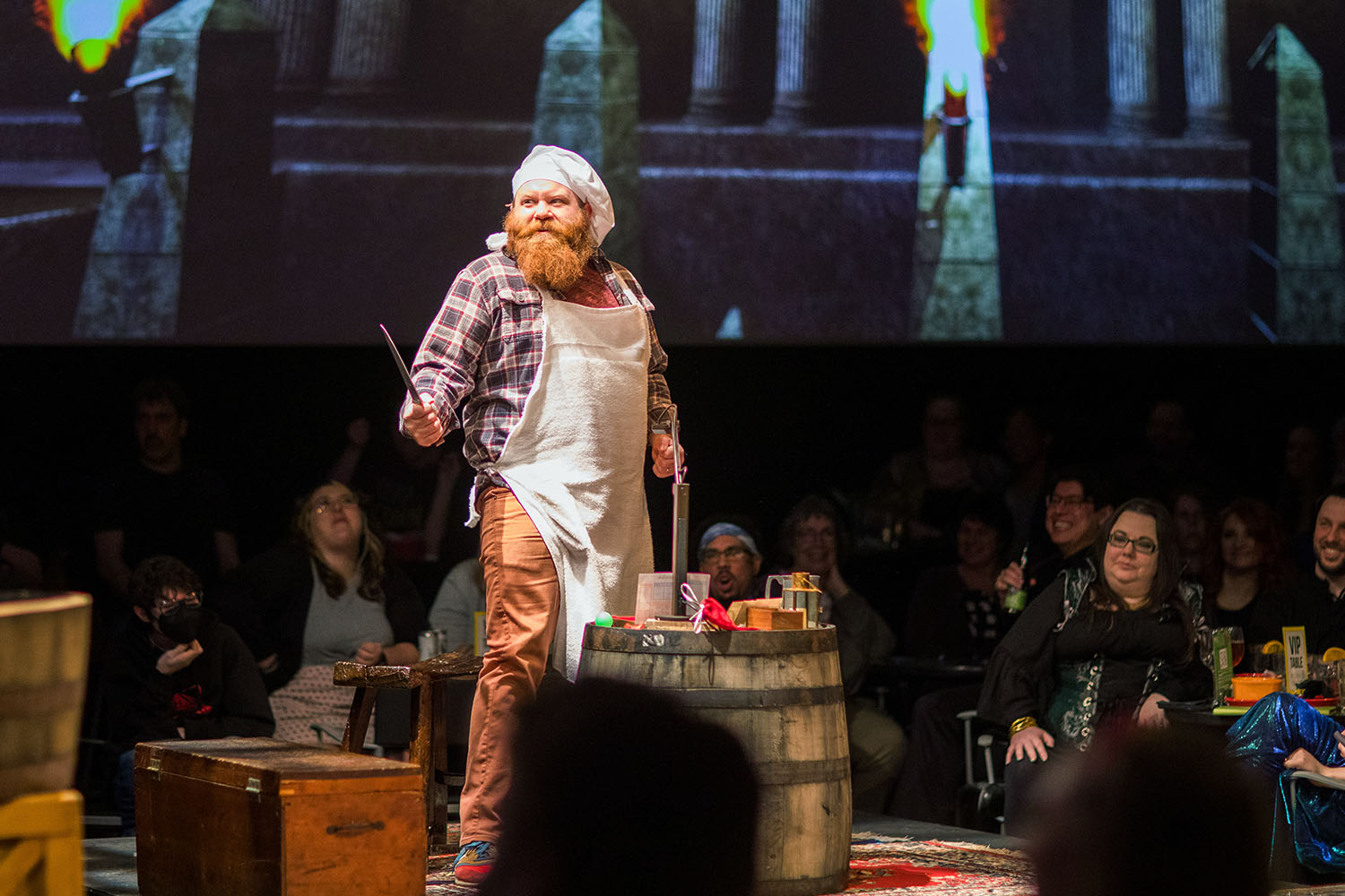 Man standing on stage in apron