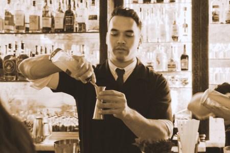 Bartender making drinks at a bar