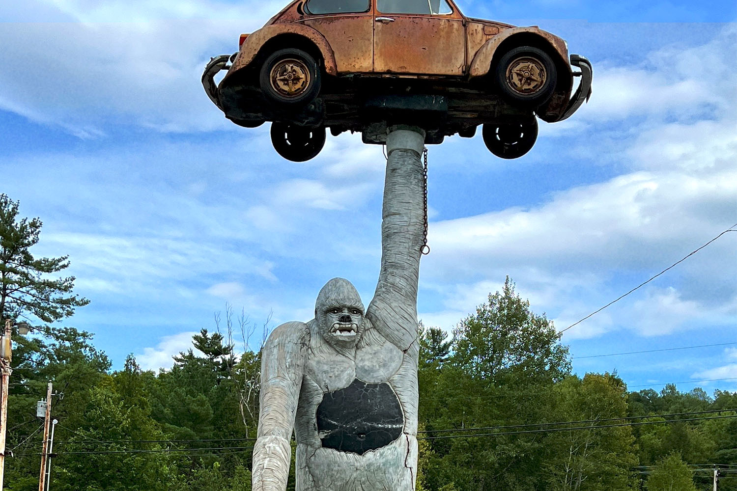 Gorilla statue holding up a car