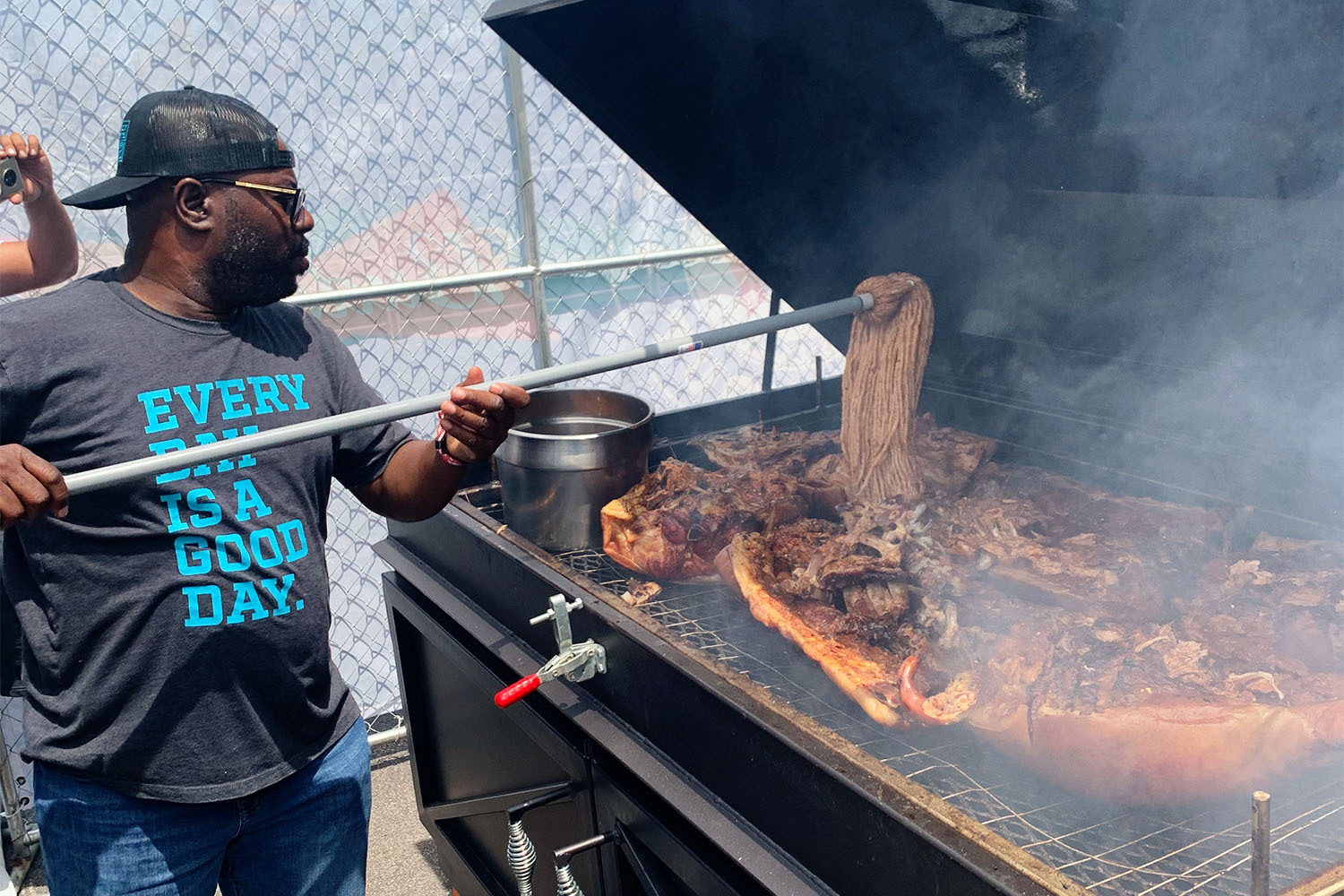 Chef Rodney Scott cooks barbecue on a grill
