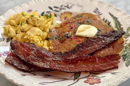Maple peppered bacon on dish with eggs