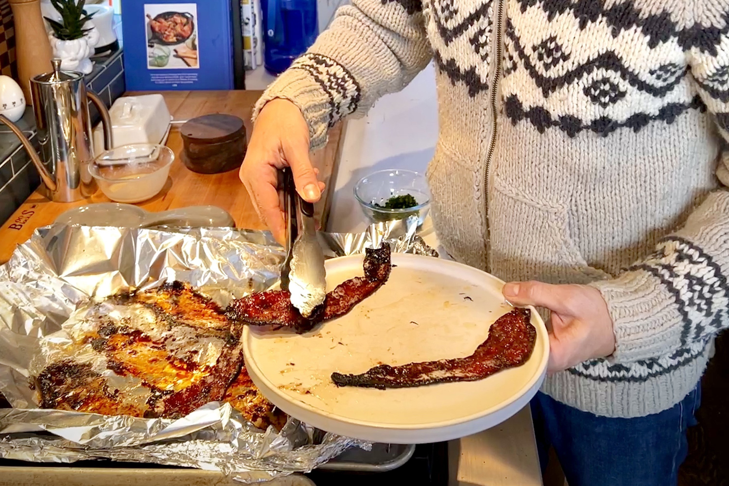 Man cooking maple peppered bacon on dish with eggs