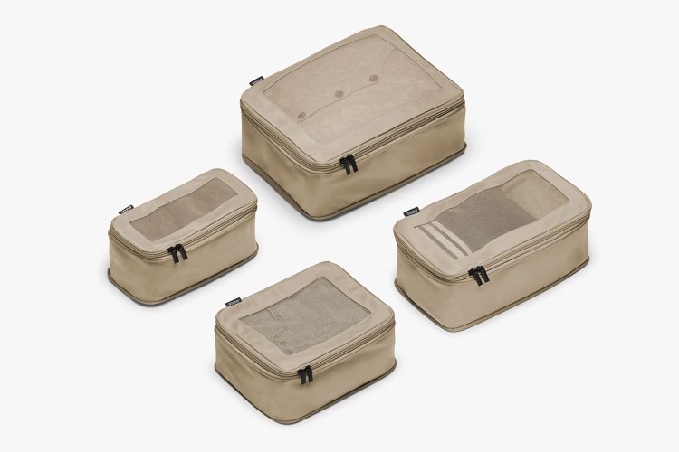 Four Tan Monos Compressible Packing Cubes on a white background