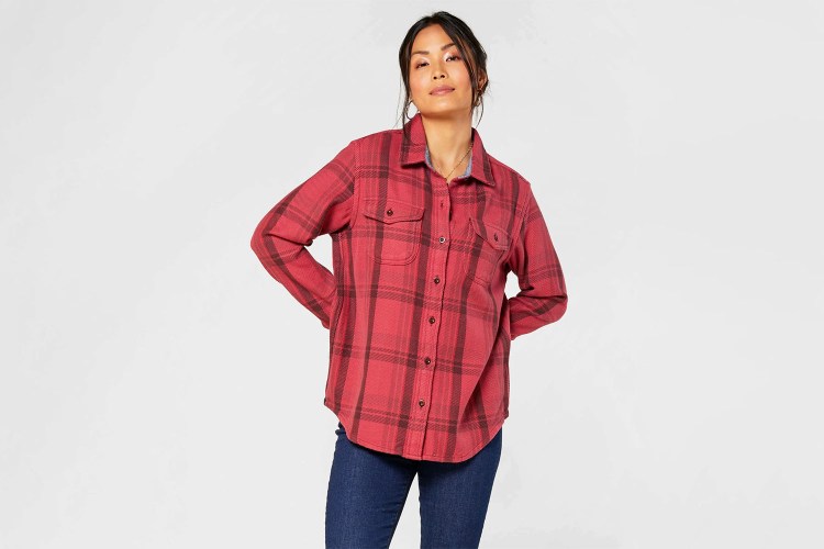 Woman wearing red plaid Outerknown Blanket Shirt