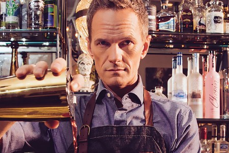 Neil Patrick Harris pouring drinks at a bar