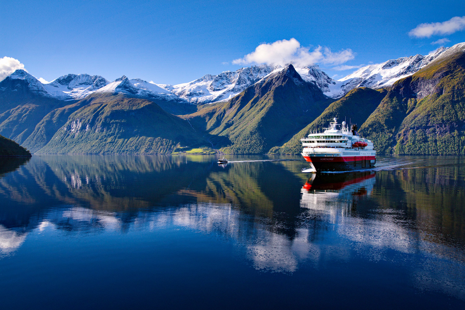 View of mountains and boat on lake in Norway