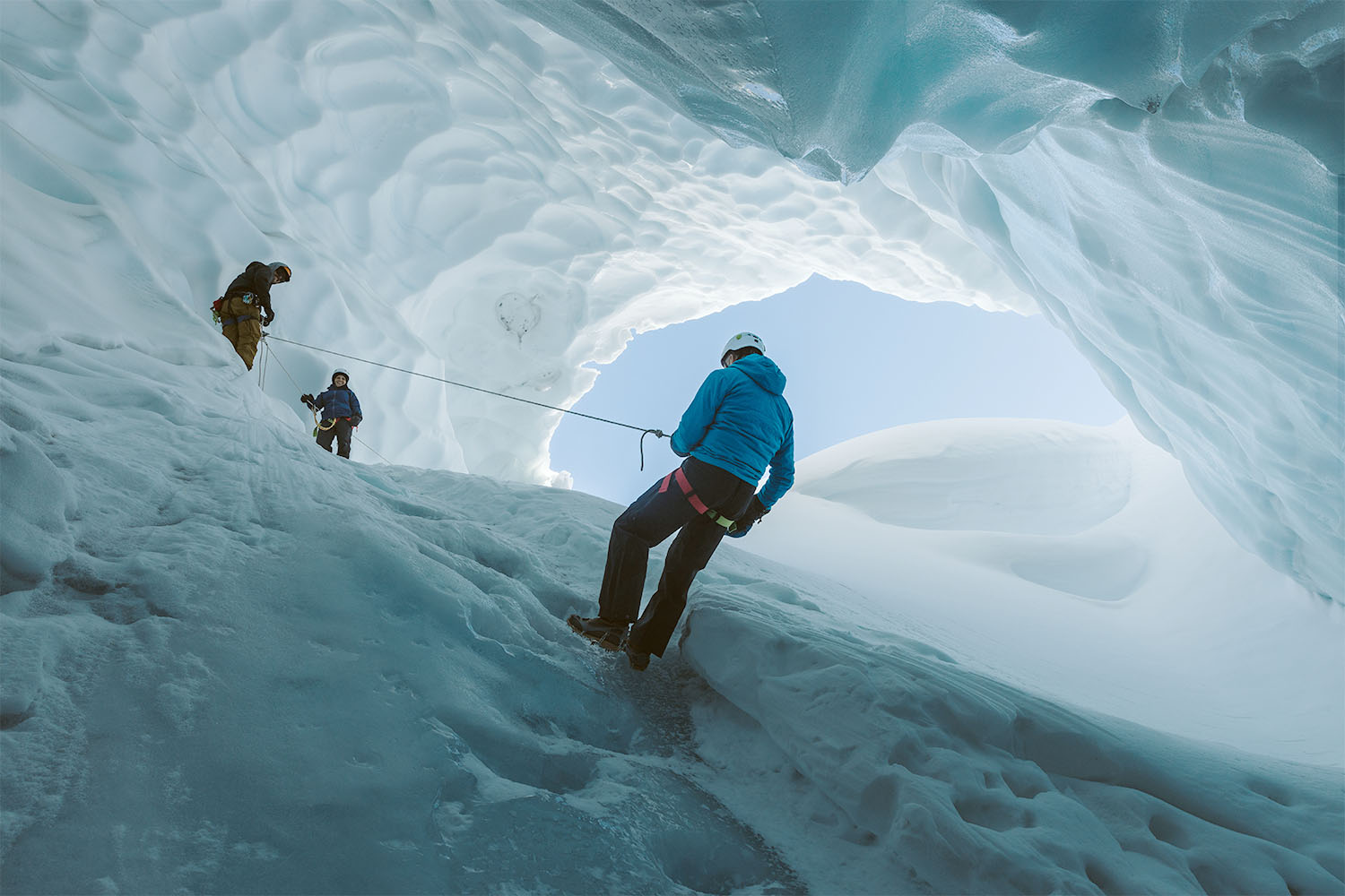 people inside of big piece of ice.