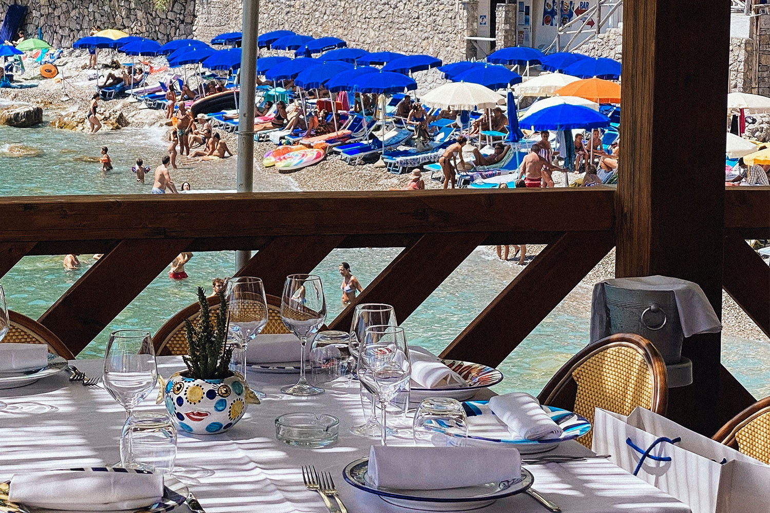 A restaurant table overlooking a beach.
