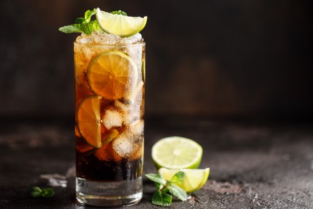Cuba Libre with brown rum, cola, mint and lime. Cuba Libre or long island iced tea cocktail with strong drinks