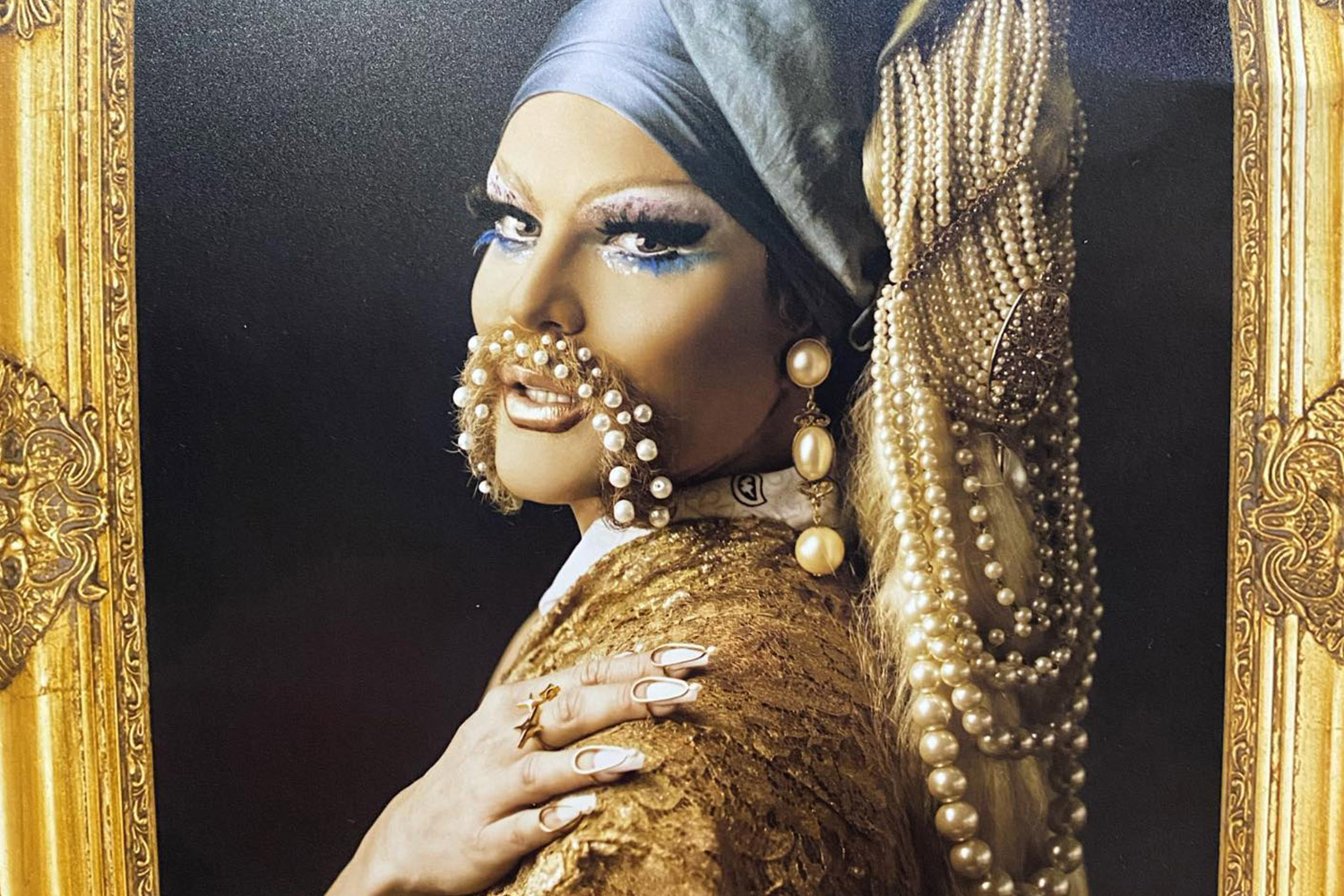 Drag queen dressed as Girl With A Pearl Earring painting