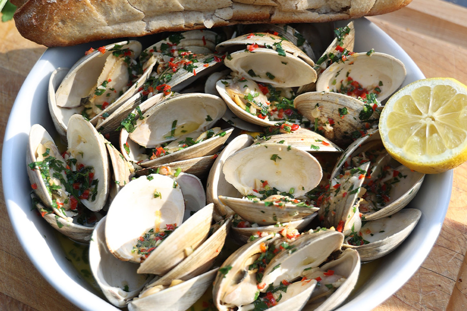 Grilled clams in dish with fresh lemon