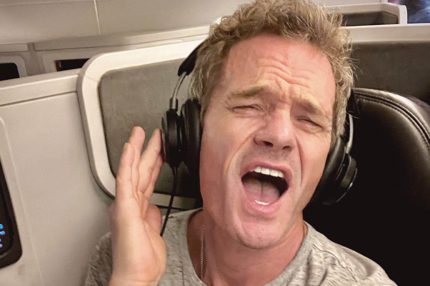 NPH with headphones on and singing.
