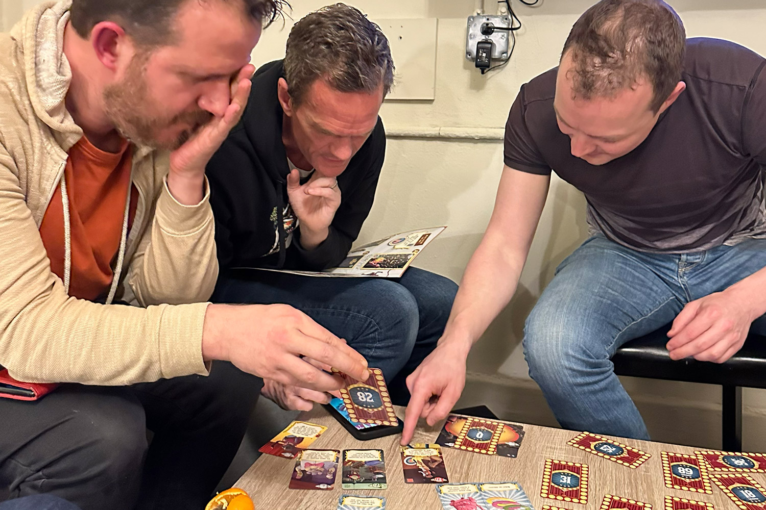 People sitting around table playing board game