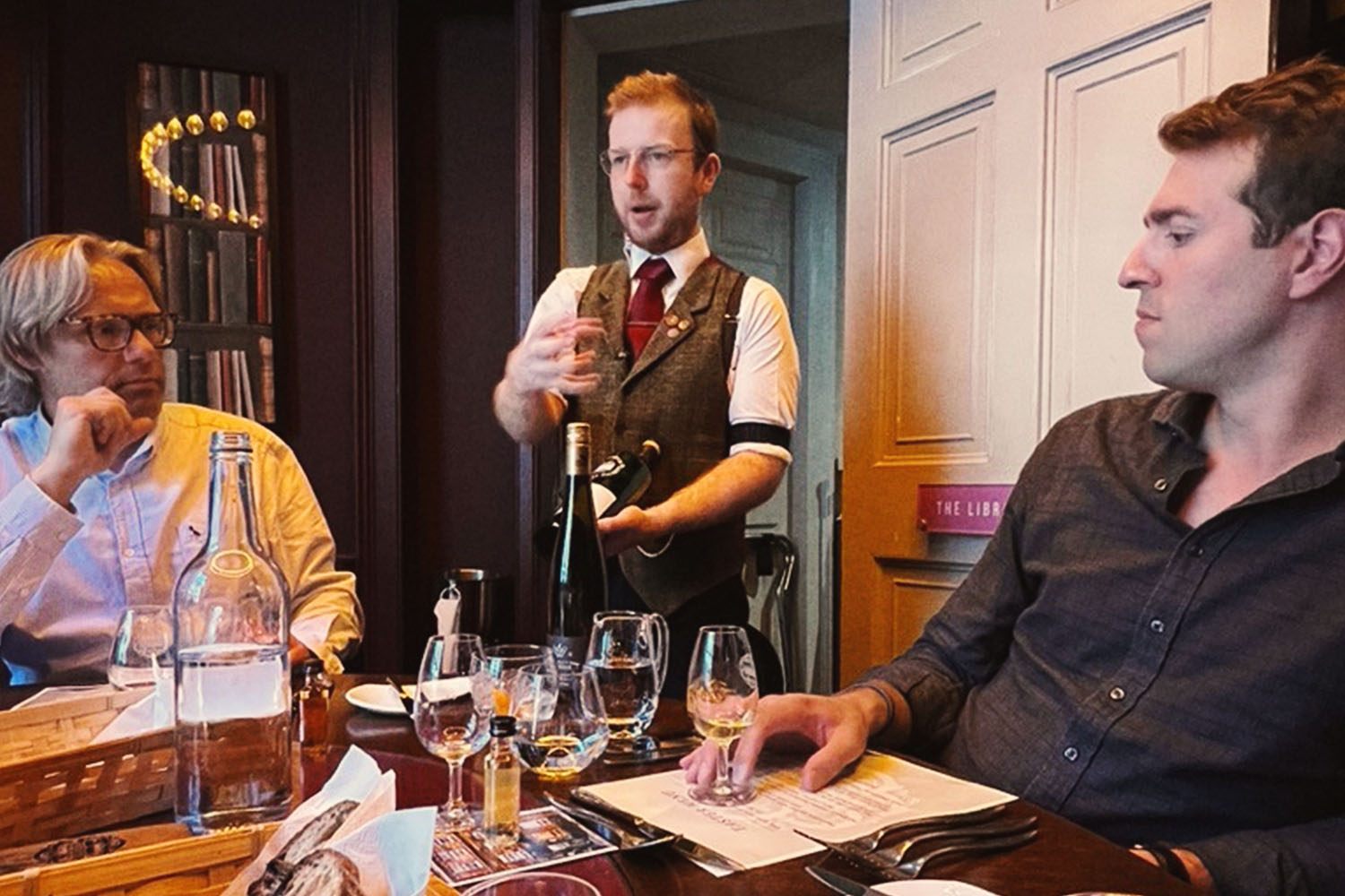 People sitting at brown table with whisky