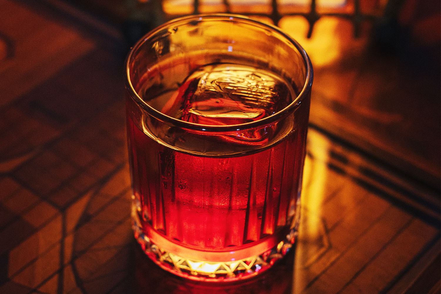 Dark-colored drink in lowball glass