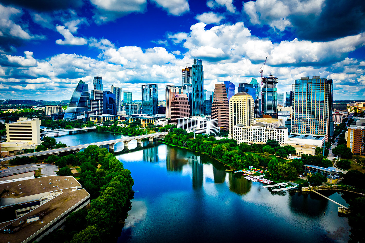 Austin, Texas skyline along the river on a blue sky and cloudy day