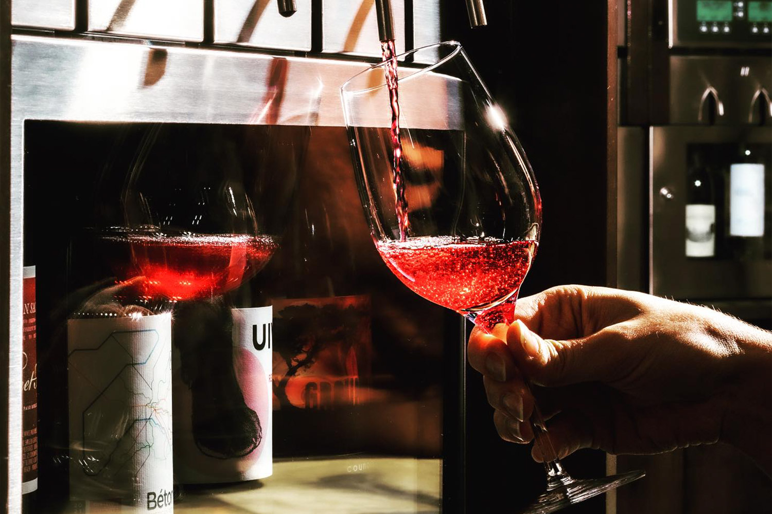 Red wine pouring from a tap