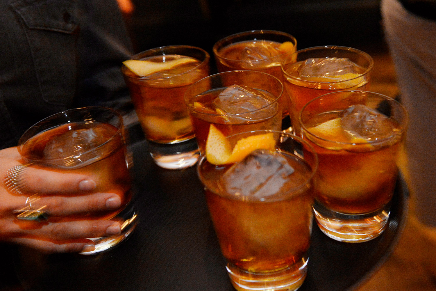 Glasses of whiskey on a tray being served