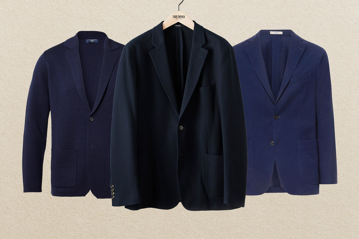 Three navy blue blazers on beige background