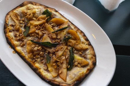 An Apple Pie Tart Flambé from above on a white plate