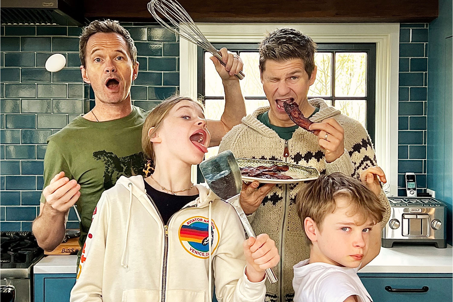 Neil Patrick Harris, David Burtka, Gideon Burtka-Harris and Harper Burtka-Harris posing in the kitchen