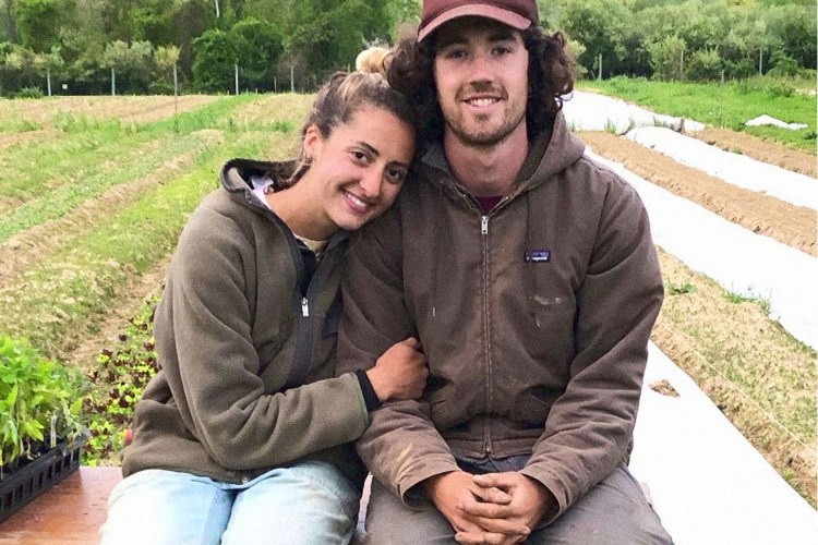 Andi Fortier and James Burke posing outside