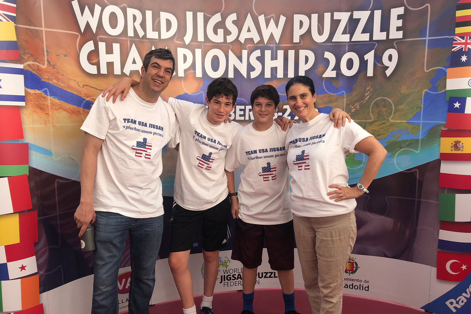 Podcast host, A.J., with two sons and wife, wearing matching "Team USA Jigsaw" shirts at the World Jigsaw Puzzle Championship 2019