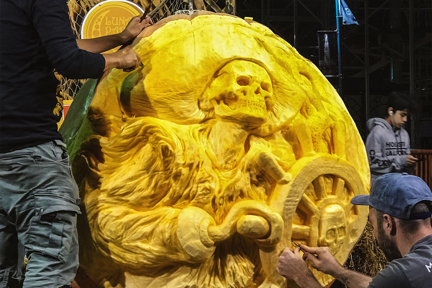 Two people carving large pumpkin