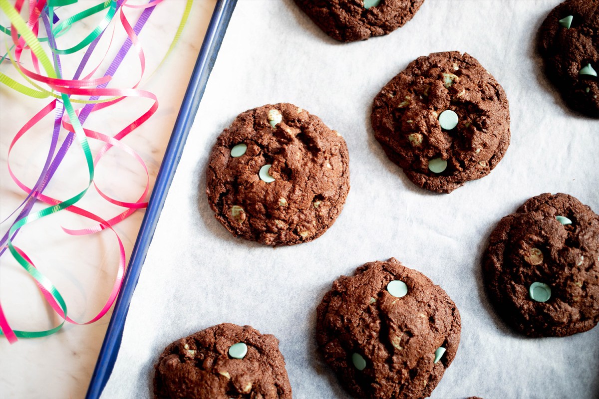 Chocolate cookies with mint green chocolate chips shown on a platter