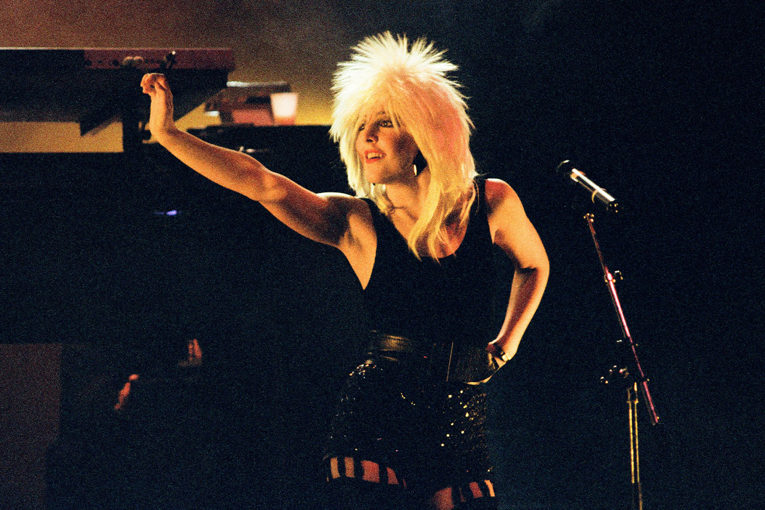 Woman performing in an 80s style blonde wig circa 1987