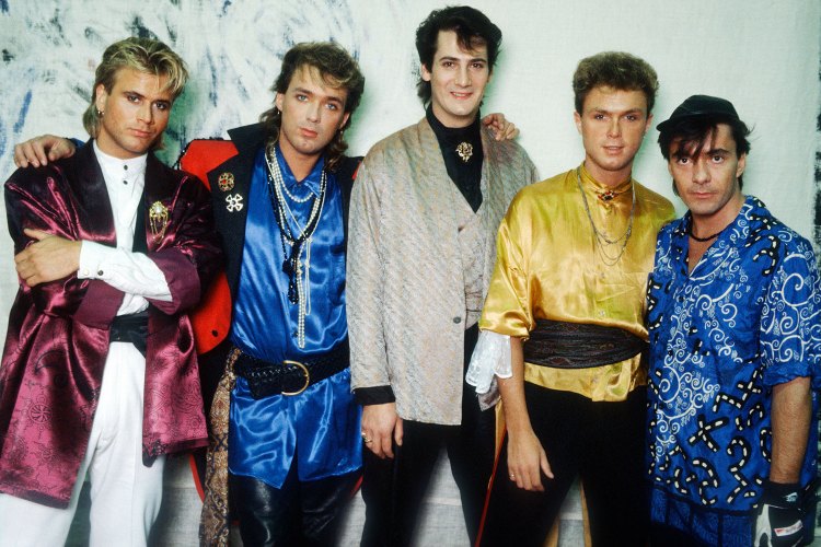 Five band members pose for a photo circa 1985