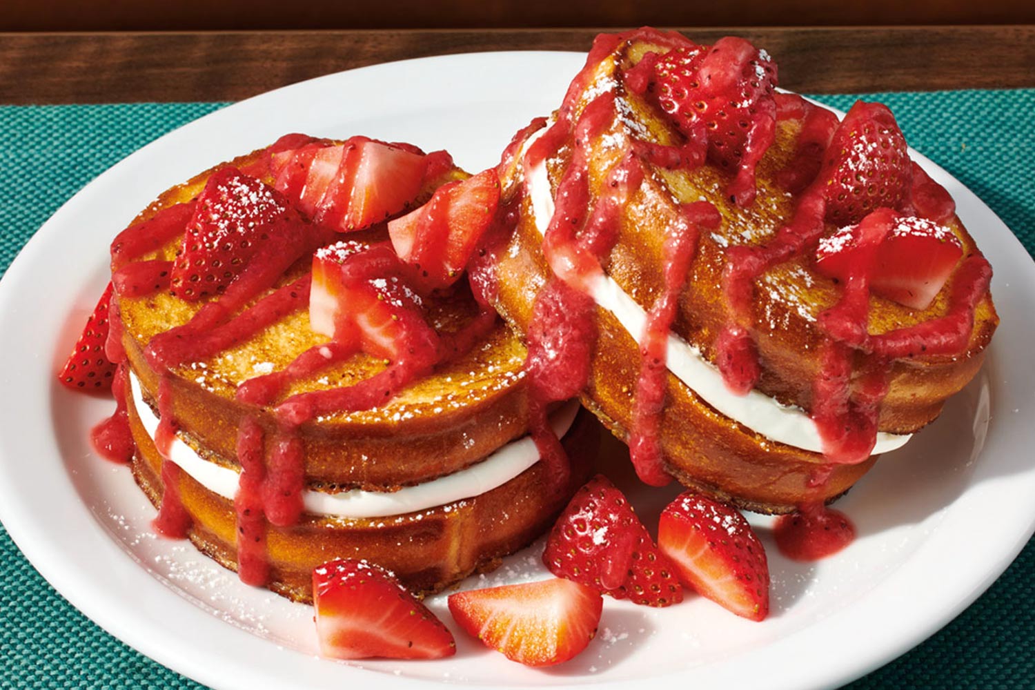 Plate of french toast with filling and strawberries