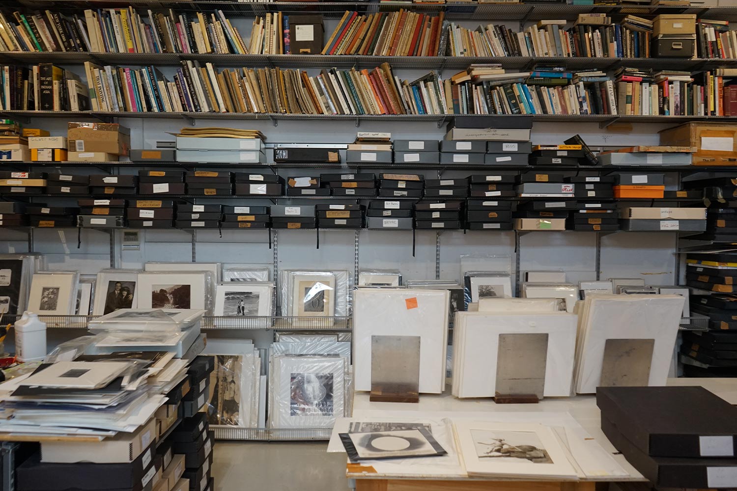 Wide-shot of a studio full of archived art and prints