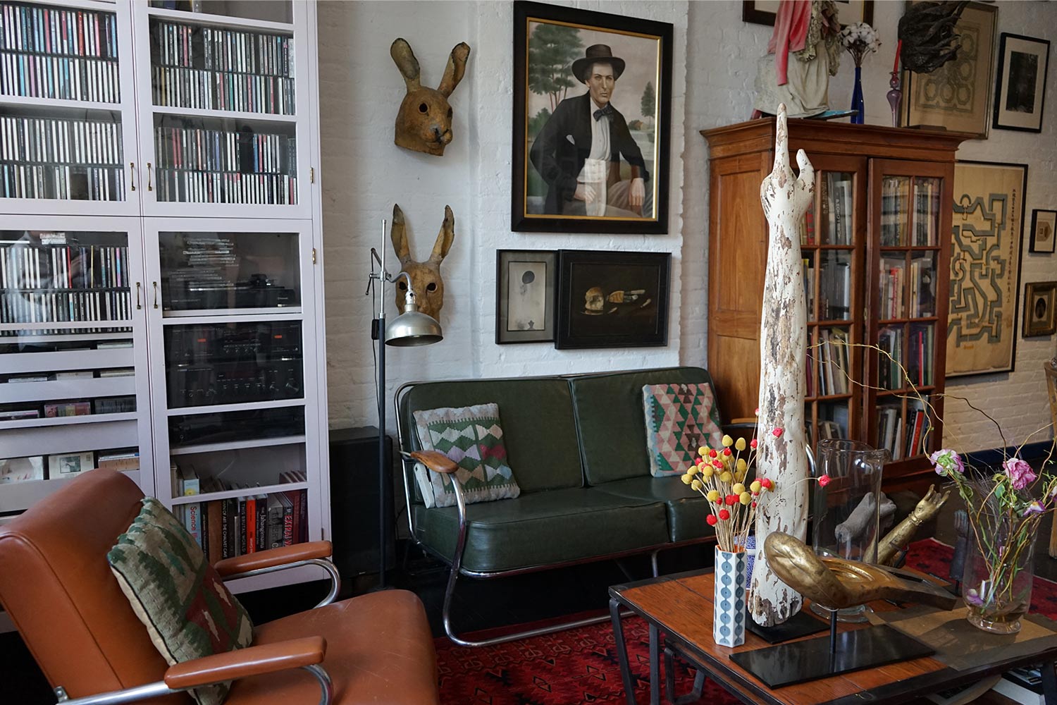 Wide-shot of an eclectic living room filled with art