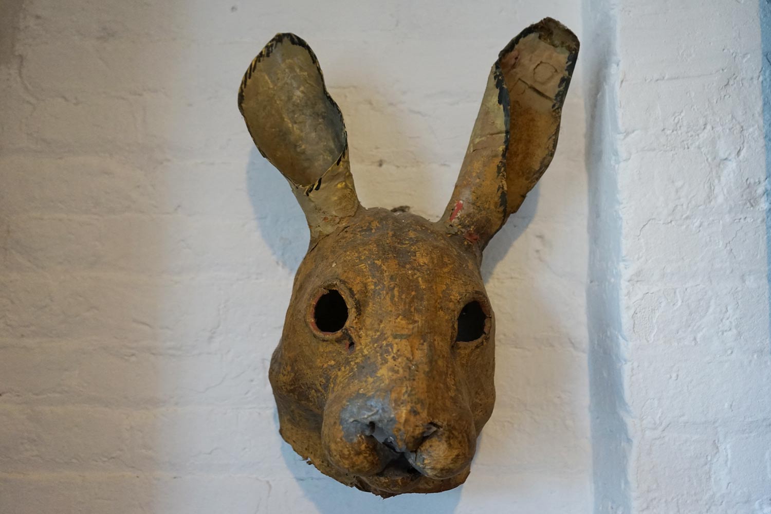 Paper mache rabbit hanging on the wall
