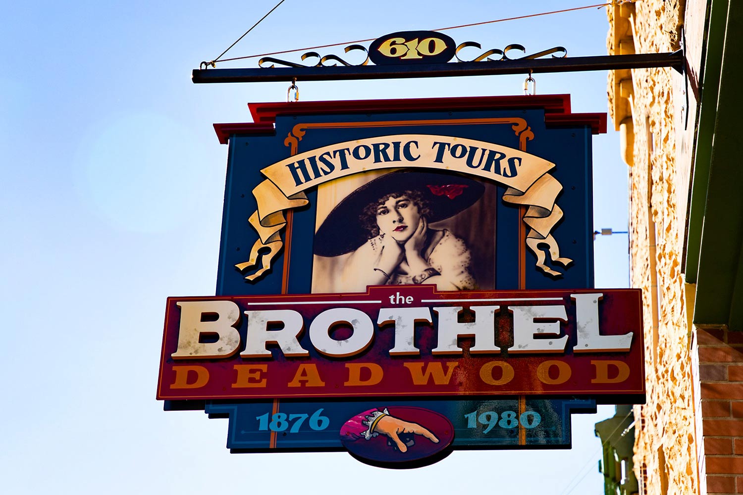 Vintage hanging sign reading, "Historic Tours, The Brothel Deadwood"